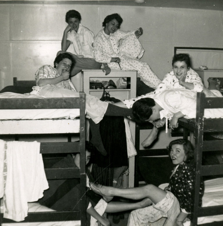 women on bunk beds posing for camera